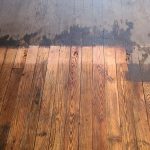 Half of wood floor clean and shiny after wood floor cleaning services in Latrobe PA