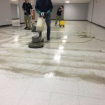 Dirty white floor being cleaned by Master Kleen professionals in commercial cleaning in North Huntingdon, PA